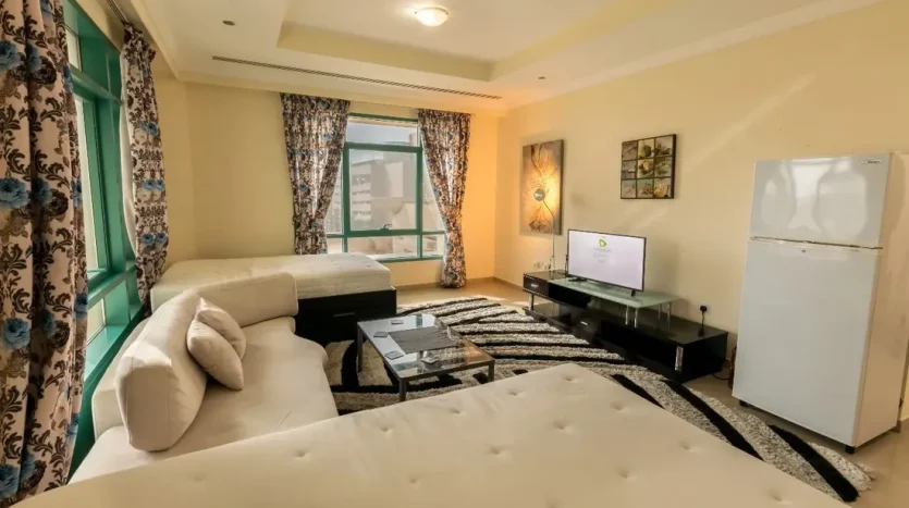 this picture includes a bed, screen, and sofa in a bed space available for rent in Marina Dubai.