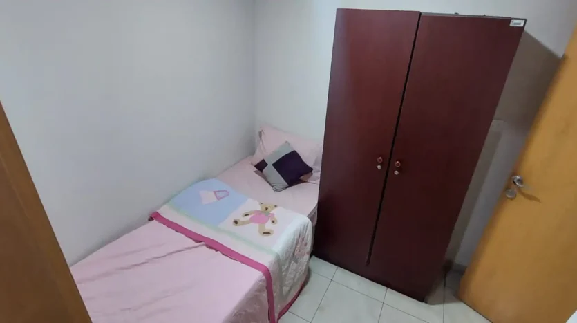 this picture shows a bed and treasury inside a single bedroom for rent in Marina Dubai at Newbai.