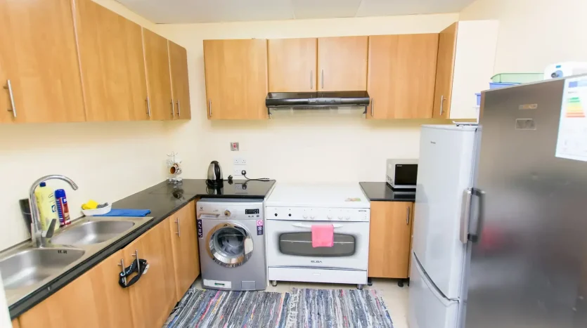 this picture shows a kitchen in a single room avavilable for rent in Marina Dubai.