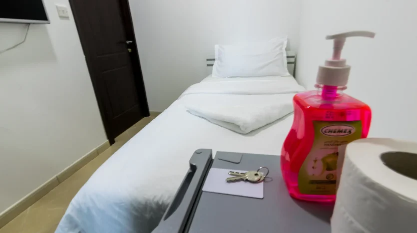 This picture includes a bed in a typical room available for rent in Dubai Marina at a special price.