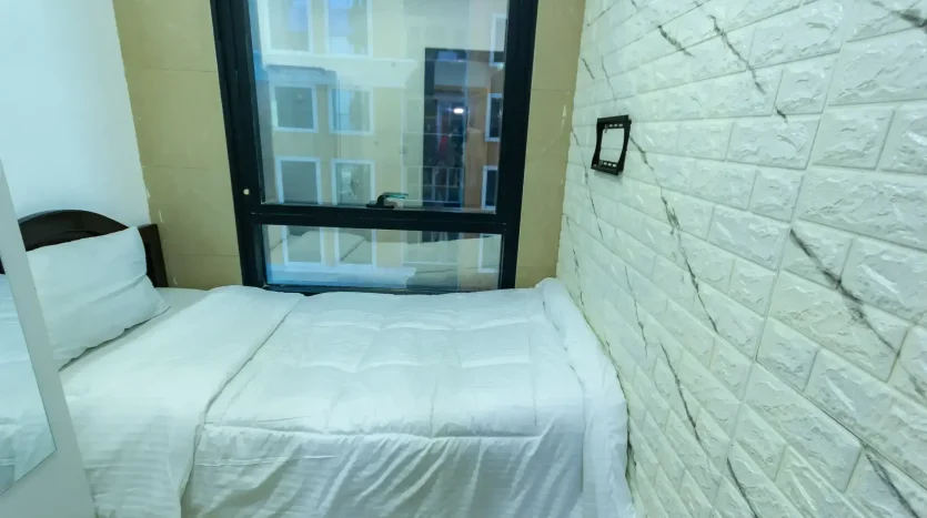 this image includes a bed in a room in Marina available for rent at an exclusive price with Newbai