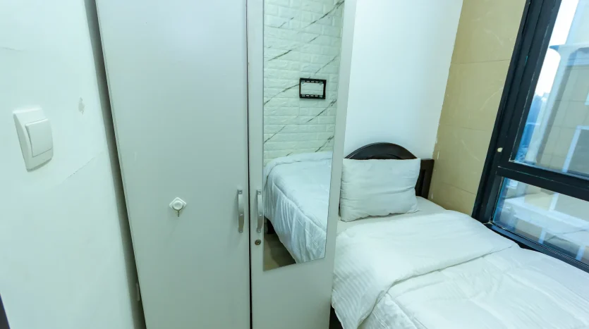 this picture shows single bed in a solo room in Dubai Marina available for rent with newbai.