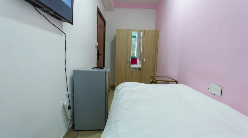 an image about a bed and screen tv in a single room in Dubai Marina at Newbai company for real estate