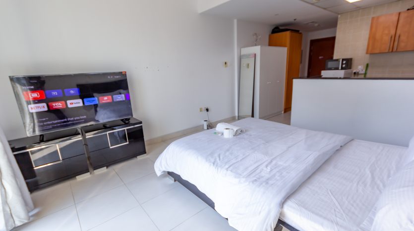 this picture shows a bed and TV screen in a Studio for Rent in Marina