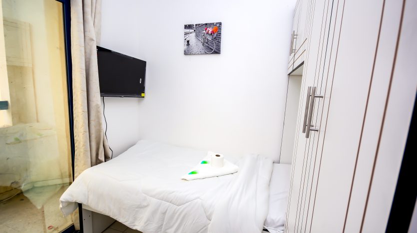 This picture shows a single bed and TV Screen in a Partition in Bin Daher