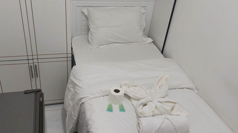 This picture shows a bed in a partition for rent in Al Qusais - Dubai.