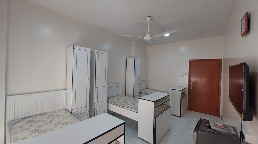 This picture shows two beds in a master room in Al Qusais for rent.