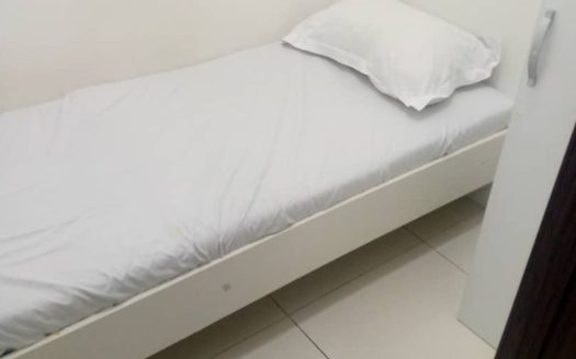 This image includes a bed in a Room For Rent in Al Quoz - Dubai