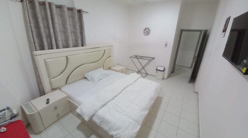 This picture shows a semi-master room in Al Qusais with a private balcony