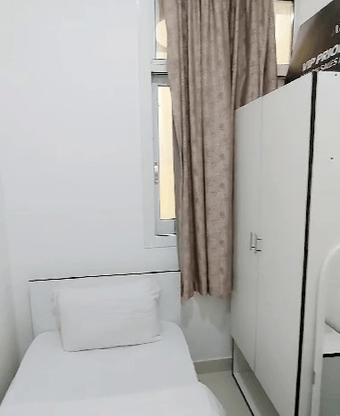 This picture shows a bed in a Small Room for Rent in Al Quoz