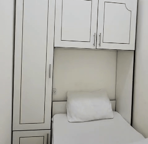 This picture shows a bed in a Small Room for Rent in Al Quoz - Dubai